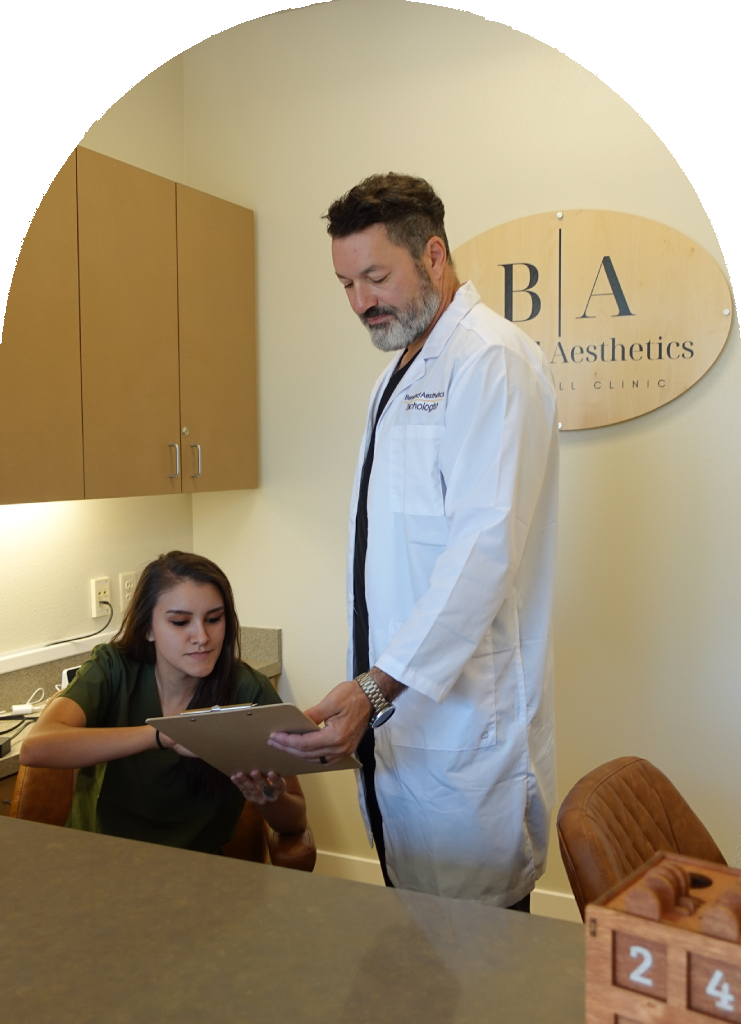 Michael Morrow and nursing staff reviewing patient charts at the front desk of Beyond Aesthetics hair restoration clinic in Salem Oregon